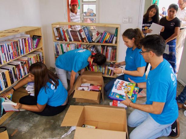 Crewmembers set up a library in a village