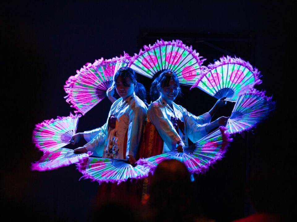 Korean fan dance group performs during an onboard event.