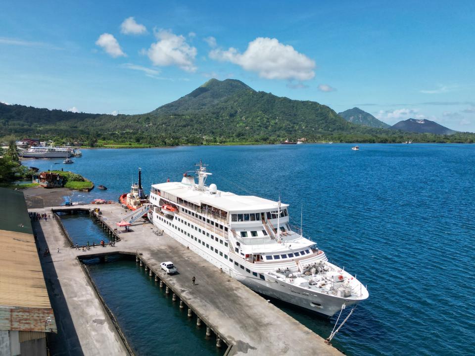 Rabaul, Papua New Guinea :: Drone view of Doulos Hope at the berth with the volcano in the background.