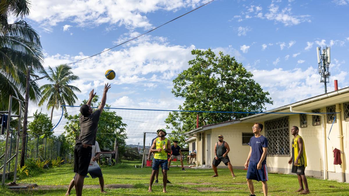 Suva, Fiji :: A crewmember plays a game with residents from a local community centre.
