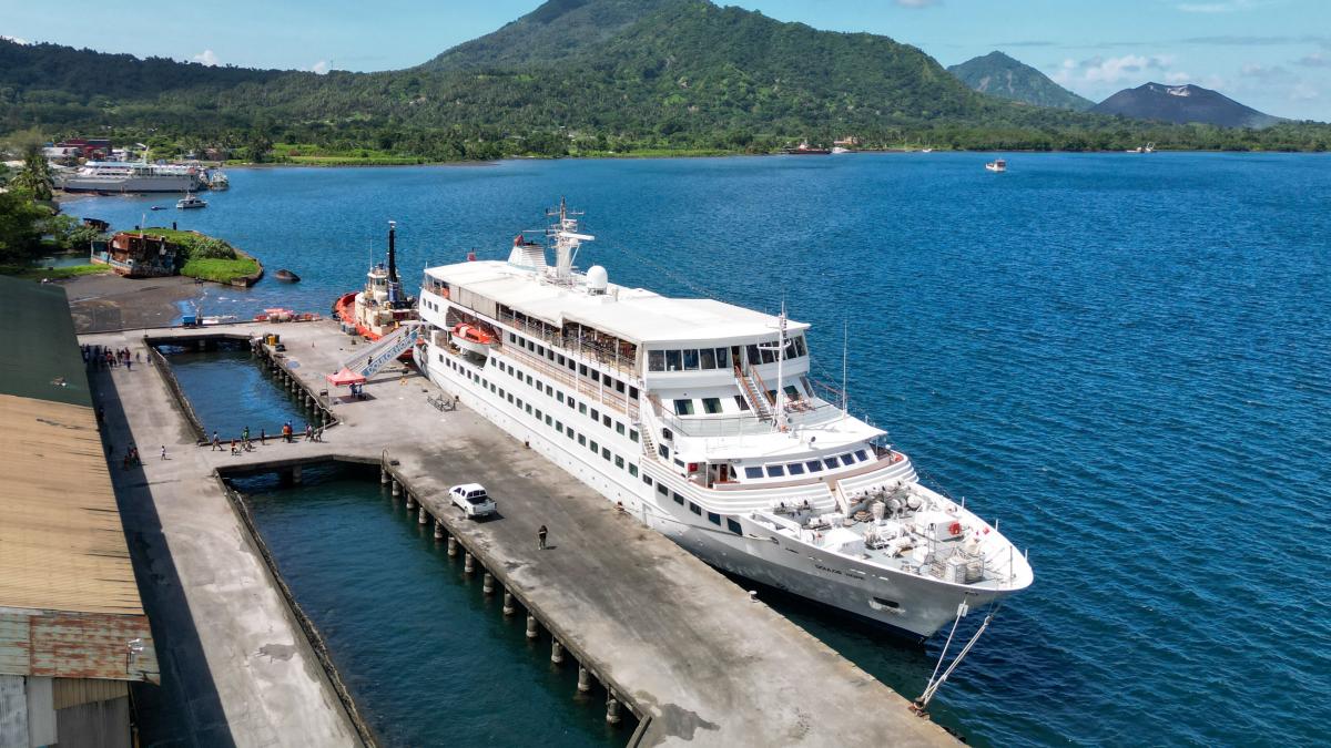 Rabaul, Papua New Guinea :: Drone view of Doulos Hope at the berth with the volcano in the background.