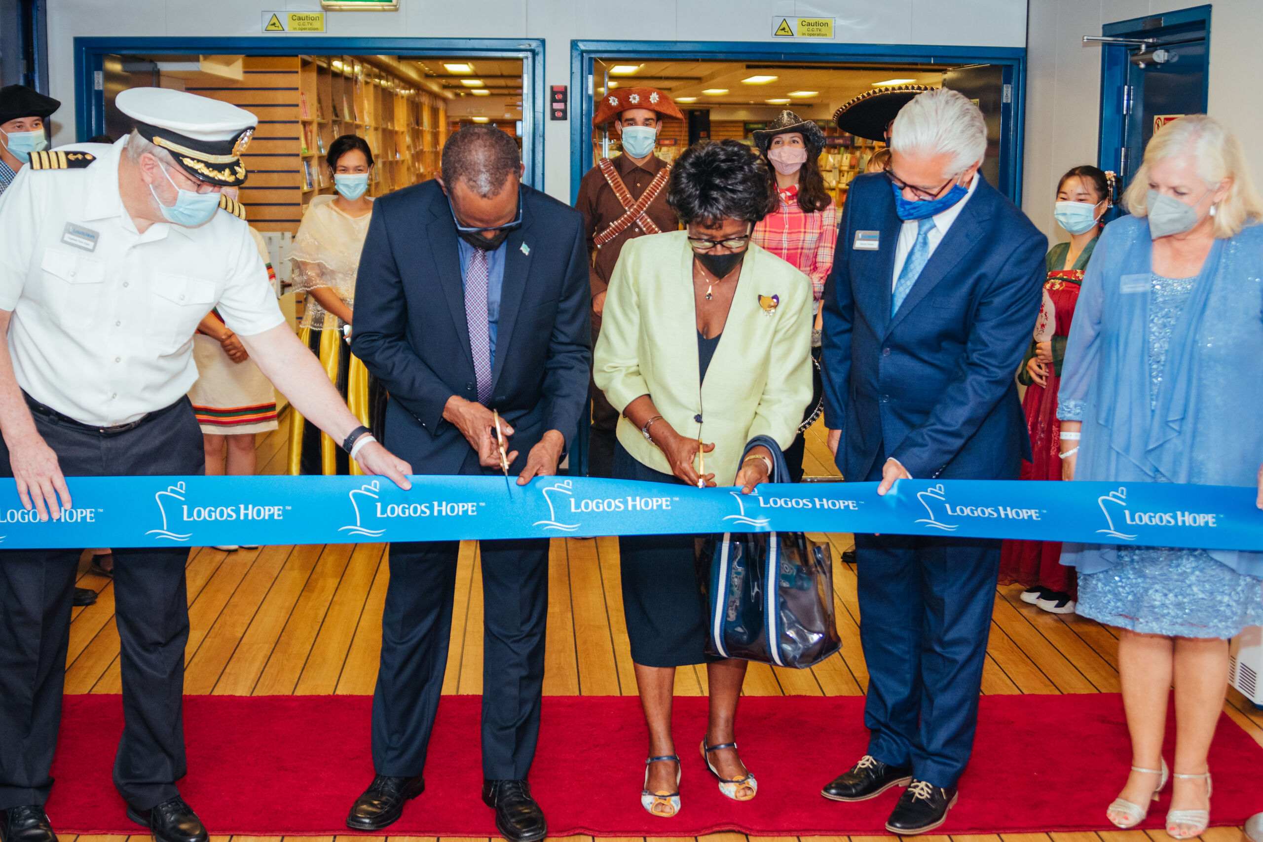 Castries, Saint Lucia :: Prime Minister Philip J. Pierre and former Governor General, Dame Pearlette Louisy (centre) cut the ribbon to declare the bookfair open to the public. Also pictured are the ship's captain, Tom Dyer (USA), director, Randy Grebe (USA) and Mrs Kim Grebe (USA, right).